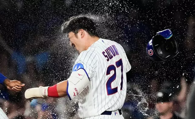 Chicago Cubs' Seiya Suzuki of Japan, celebrates with a teammate after hitting a walk-off one-run single during the ninth inning of a baseball game against the San Diego Padres in Chicago, Monday, June 29, 2026. (AP Photo/Nam Y. Huh)