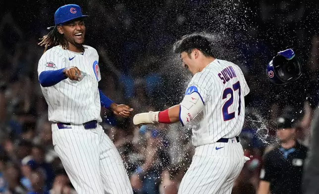 Chicago Cubs' Seiya Suzuki, right, of Japan, celebrates with a teammate after hitting a walk-off one-run single during the ninth inning of a baseball game against the San Diego Padres in Chicago, Monday, June 29, 2026. (AP Photo/Nam Y. Huh)