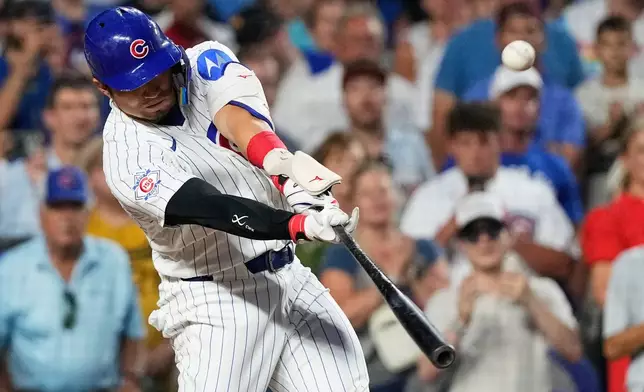 Chicago Cubs' Seiya Suzuki of Japan, hits a sacrifice fly to San Diego Padres center fielder Jackson Merrill during the fifth inning of a baseball game in Chicago, Monday, June 29, 2026. (AP Photo/Nam Y. Huh)