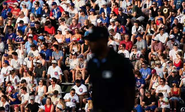 Baseball fans watch during the first inning of a baseball game between the San Diego Padres and the Chicago Cubs in Chicago, Monday, June 29, 2026. (AP Photo/Nam Y. Huh)