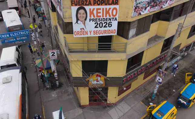 A banner of Presidential candidate Keiko Fujimori of the Popular Force party, is seen on the balcony of a house in Lima, Peru, Friday, June 5, 2026, ahead of their presidential runoff election. (AP Photo/Rodrigo Abd)