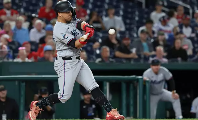 Miami Marlins' Heriberto Hernández hits a two-run home run off Washington Nationals pitcher Mitchell Parker which also scored Jakob Marsee during the ninth inning of a baseball game, Tuesday, June 2, 2026, in Washington. (AP Photo/Terrance Williams)