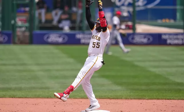 Pittsburgh Pirates' Esmerlyn Valdez celebrates as he stands on second base after hitting a double off Cincinnati Reds pitcher Brady Singer, driving in a run, during the second inning of a baseball game in Pittsburgh, Sunday, June 28, 2026. (AP Photo/Gene J. Puskar)