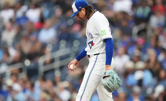 Toronto Blue Jays pitcher Kevin Gausman reacts after giving up a solo home run to Texas Rangers designated hitter Joc Pederson during the first inning of a baseball game in Toronto, Thursday, June 25, 2026. (Nathan Denette/The Canadian Press via AP)