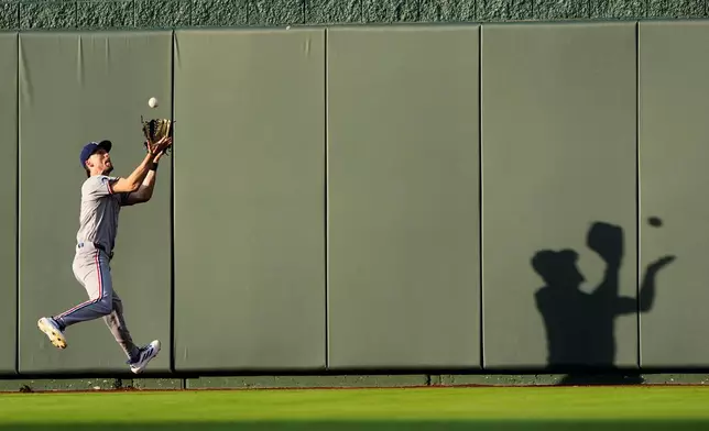 Texas Rangers center fielder Evan Carter catches a line drive for the out on Kansas City Royals' Maikel Garcia during the third inning of a baseball game Wednesday, June 10, 2026, in Kansas City, Mo. (AP Photo/Charlie Riedel)