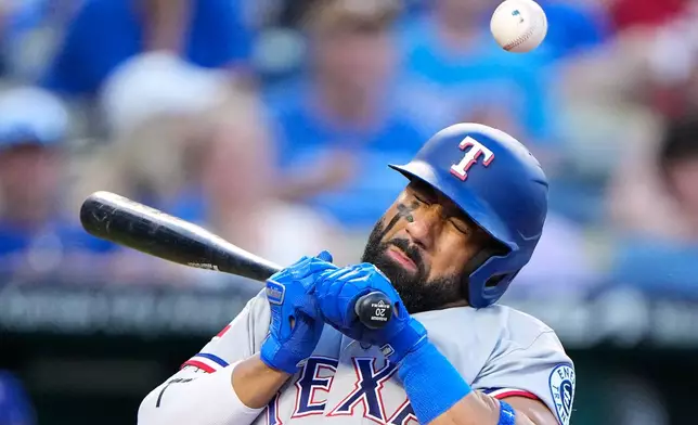 Texas Rangers' Ezequiel Duran reacts after being hit by a pitch thrown by Kansas City Royals pitcher Mason Black during the fourth inning of a baseball game, Wednesday, June 10, 2026, in Kansas City, Mo. (AP Photo/Charlie Riedel)