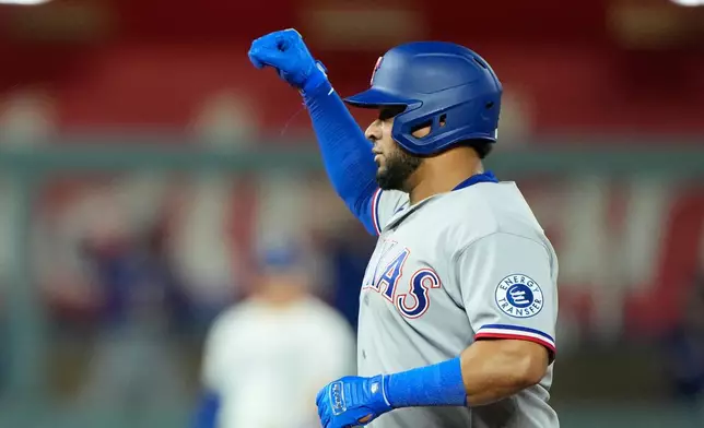 Texas Rangers' Elias Diaz celebrates on second after hitting an RBI double during the 10th inning of a baseball game against the Kansas City Royals, Wednesday, June 10, 2026, in Kansas City, Mo. (AP Photo/Charlie Riedel)