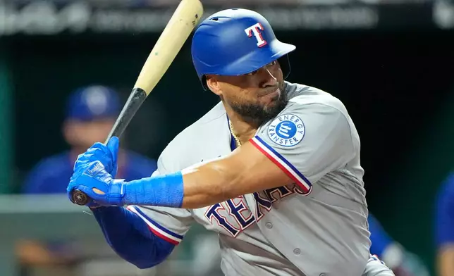 Texas Rangers' Elias Diaz waits to hit an RBI double during the 10th inning of a baseball game against the Kansas City Royals, Wednesday, June 10, 2026, in Kansas City, Mo. (AP Photo/Charlie Riedel)