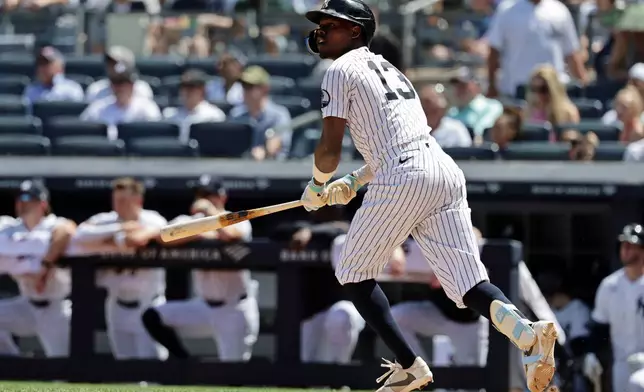 New York Yankees' Jazz Chisholm Jr. watches his sacrifice fly during the fourth inning of a baseball game against the Cleveland Guardians, Thursday, June 4, 2026, in New York. (AP Photo/Adam Hunger)