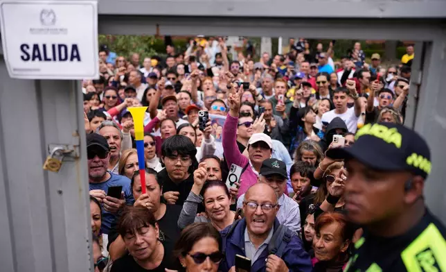 Supporters of presidential candidate Ivan Cepeda of the ruling Historic Pact coalition gather outside the polling station where he voted during the presidential election in Bogota, Colombia, Sunday, May 31, 2026. (AP Photo/Matias Delacroix)
