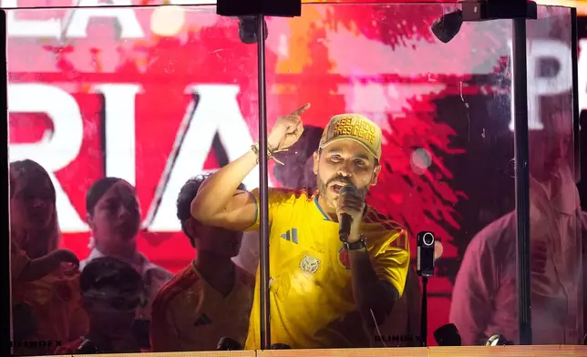 Presidential candidate Abelardo de la Espriella of the Defenders of the Motherland movement addresses supporters from inside a bulletproof booth after leading the first round of the presidential election and advancing to a runoff in Barranquilla, Colombia, Sunday, May 31, 2026. (AP Photo/Fernando Vergara)
