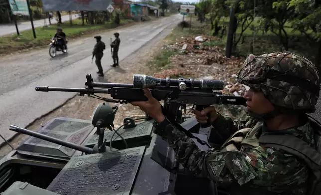 Soldiers guard during the presidential election in Santander de Quilichao, Colombia, Sunday, May 31, 2026. (AP Photo/Santiago Saldarriaga)