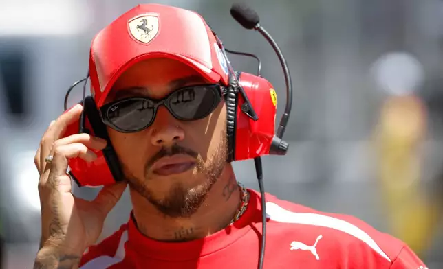 Ferrari driver Lewis Hamilton of Britain adjusts his headphones at pit during the first free practice for the Spain F1 Grand Prix at the Barcelona Catalunya racetrack in Montmelo, near Barcelona, Spain, Friday, June 12, 2026. (AP Photo/Joan Monfort)