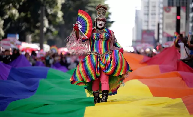 A reveler in costume attends the annual Pride Parade in Sao Paulo, Brazil, Sunday, June 7, 2026. (AP Photo/Ettore Chiereguini)