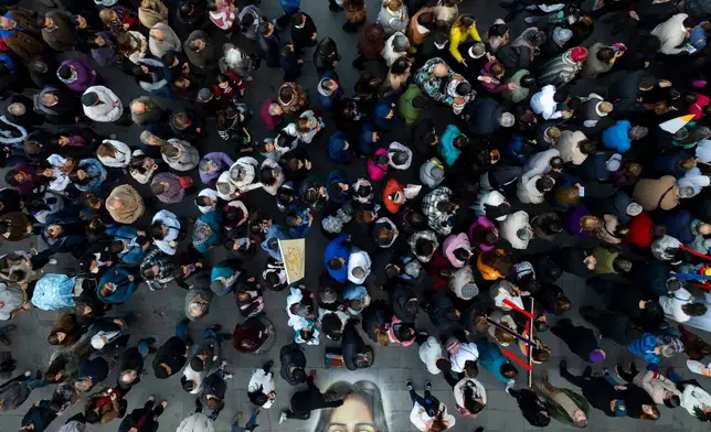 People participate in a procession marking the Catholic feast of Corpus Christi in Plaza de Armas in Santiago, Chile, Sunday, June 7, 2026. (AP Photo/Esteban Felix)