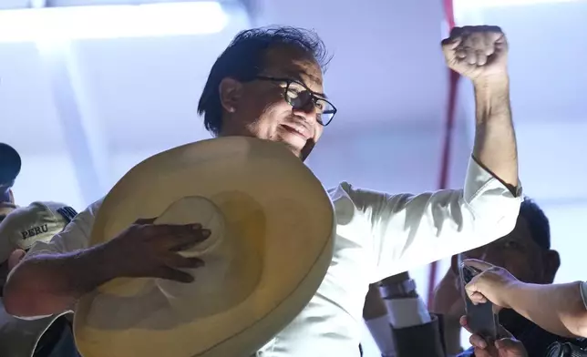 Presidential candidate Roberto Sanchez of the Together for Peru party appears on the balcony of his campaign headquarters after polls closed in the presidential runoff election in Lima, Peru, Sunday, June 7, 2026 (AP Photo/Rodrigo Abd)