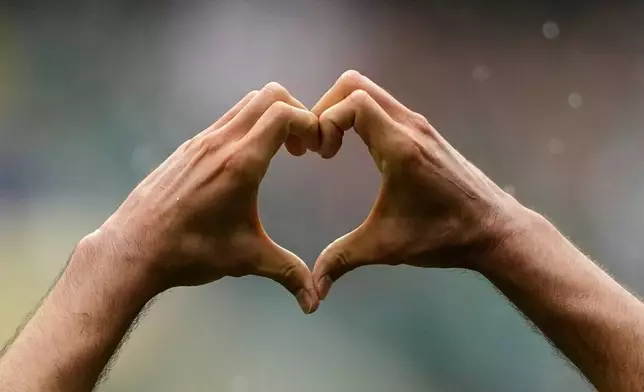 Mexico's Raul Jimenez makes a heart gesture as he celebrates after scoring his side's second goal during the World Cup Group A soccer match between Mexico and South Africa in Mexico City, Thursday, June 11, 2026. (AP Photo/Natacha Pisarenko)