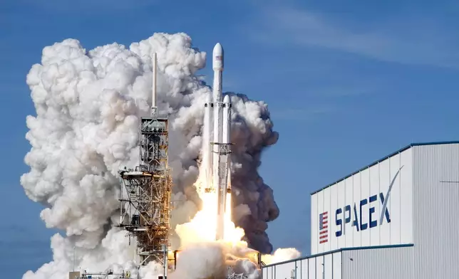 FILE - A Falcon 9 SpaceX heavy rocket lifts off from pad 39A at the Kennedy Space Center in Cape Canaveral, Fla., Tuesday, Feb. 6, 2018. (AP Photo/John Raoux, File)