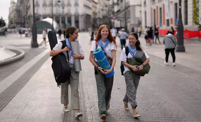 Pilgrims walk through Madrid ahead of Pope Leo XIV's visit to Spain, Saturday, June 6, 2026. (AP Photo/Bernat Armangue)