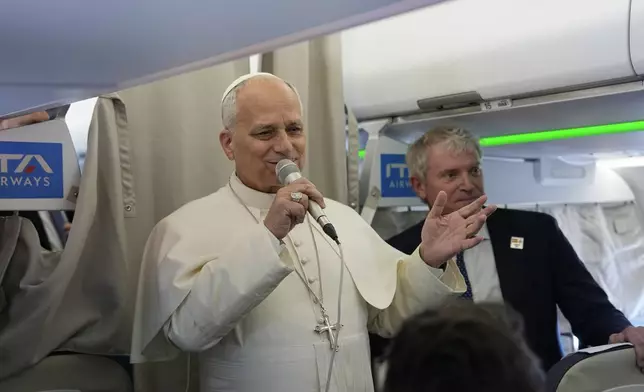Pope Leo XIV talks to journalists aboard the papal flight from Rome to Madrid, Saturday, June 6, 2026, on the occasion of his apostolic journey to Spain. (AP Photo/Alessandra Tarantino, Pool)