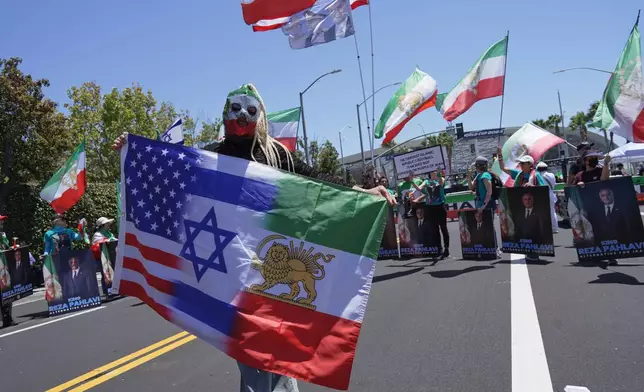 People protest outside Los Angeles Stadium before the World Cup Group G soccer match between Iran and New Zealand in Inglewood, Calif., near Los Angeles, Monday, June 15, 2026 (AP Photo/Ty ONeil)