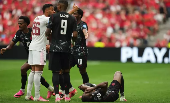 Canada's Ismael Kone, right, lays on the ground after sustaining an injury during the World Cup Group B soccer match against Qatar in Vancouver, British Columbia, Thursday, June 18, 2026. (AP Photo/Abbie Parr)