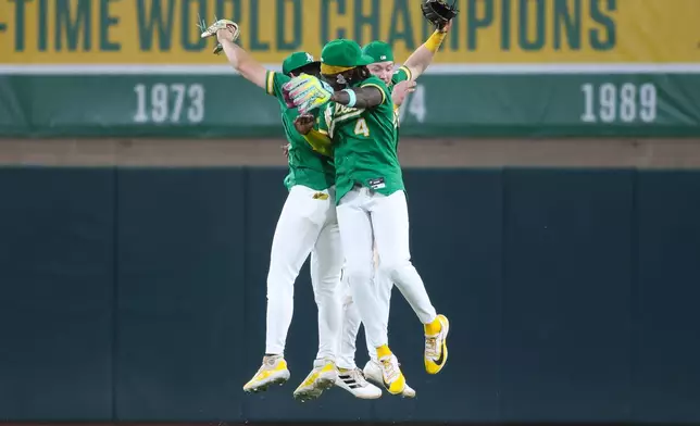 Athletics' Tyler Soderstrom, left, Lawrence Butler (4), and Henry Bolte celebrate the Athletics win over the Pittsburgh Pirates in a baseball game Monday, June 15, 2026, in West Sacramento, Calif. (AP Photo/Scott Marshall)
