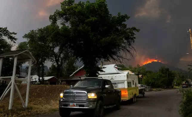 Residents rush to evacuate as winds drive the Iron Fire towards Eureka, Utah, on Saturday, June 20, 2026.(The Deseret News via AP)