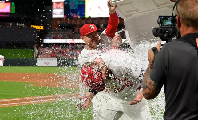 St. Louis Cardinals starting pitcher Dustin May, center, is doused after the team defeated the San Diego Padres in a baseball game, Monday, June 15, 2026, in St. Louis. (AP Photo/Joe Puetz)