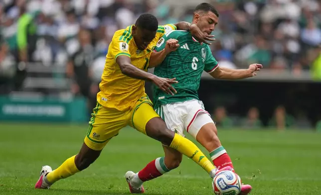 South Africa's Sphephelo Sithol, left, and Mexico's Erik Lira battle for the ball during the World Cup Group A soccer match between Mexico and South Africa in Mexico City, Thursday, June 11, 2026. (AP Photo/Silvia Izquierdo)