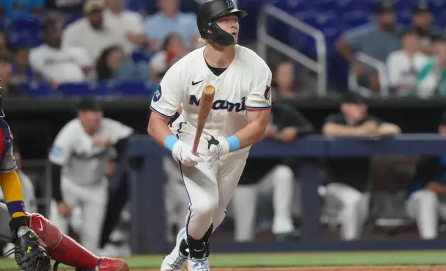 Miami Marlins' Kyle Stowers watches his hit to center field during the sixth inning of a baseball game against the Arizona Diamondbacks Tuesday, June 9, 2026, in Miami. (AP Photo/Marta Lavandier)