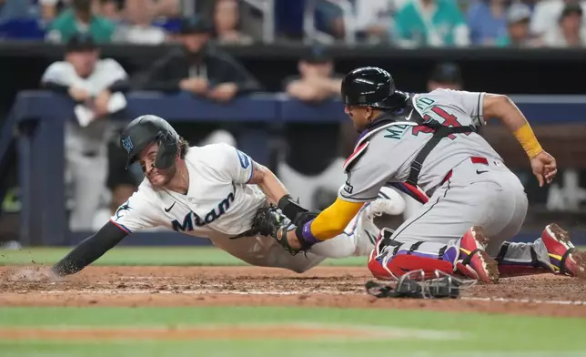Arizona Diamondbacks catcher Gabriel Moreno (14) tags out Miami Marlins' Connor Norby at home plate during the sixth inning of a baseball game Tuesday, June 9, 2026, in Miami. (AP Photo/Marta Lavandier)