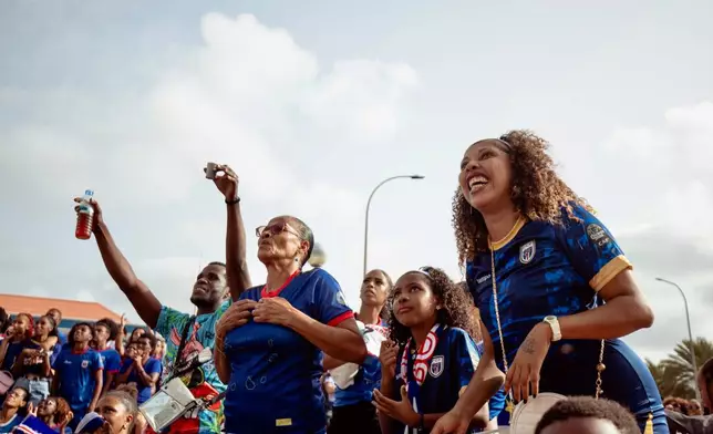 Fans react as they watch a broadcast of the World Cup Group H soccer match between Cape Verde and Spain at a viewing center in Mindelo, São Vicente, Cape Verde, Monday, June 15, 2026. (AP Photo/Queila Fernandes)