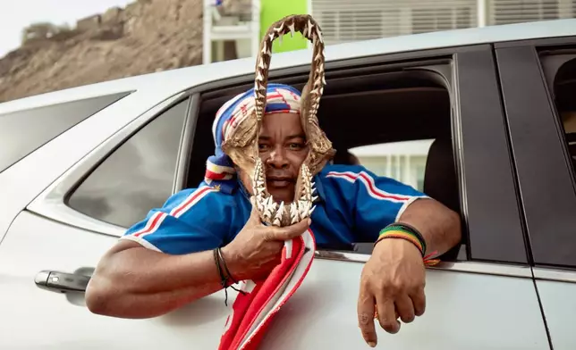 A fan celebrates in traffic after the goalless draw in the World Cup Group H soccer match between Cape Verde and Spain in Mindelo, São Vicente, Cape Verde, Monday, June 15, 2026. (AP Photo/Queila Fernandes)