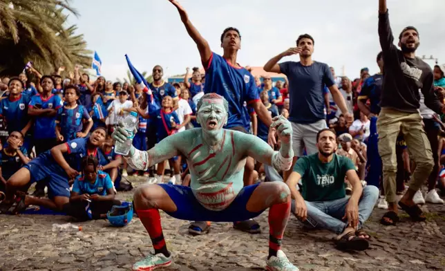 Fans react as they watch the World Cup Group H soccer match between Cape Verde and Spain at a viewing center in Mindelo, São Vicente, Cape Verde, Monday, June 15, 2026. (AP Photo/Queila Fernandes)