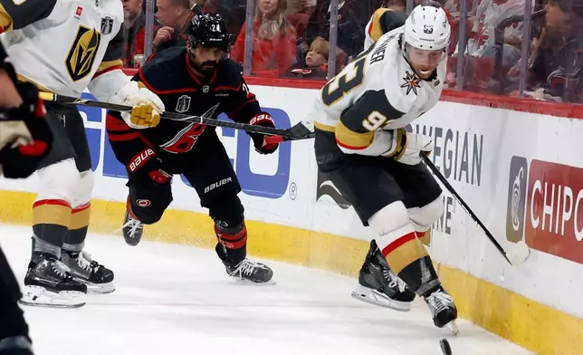 Vegas Golden Knights' Mitch Marner (93) controls the puck in front of Carolina Hurricanes' Seth Jarvis (24) during the second period in Game 2 of the NHL hockey Stanley Cup Final series in Raleigh, N.C., Thursday, June 4, 2026. (AP Photo/Karl DeBlaker)