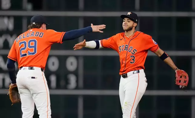 Houston Astros second baseman Raynel Delgado (29) and shortstop Jeremy Peña (3) celebrate after a baseball game against the Cleveland Guardians, Friday, June 19, 2026, in Houston. (AP Photo/Kevin M. Cox)