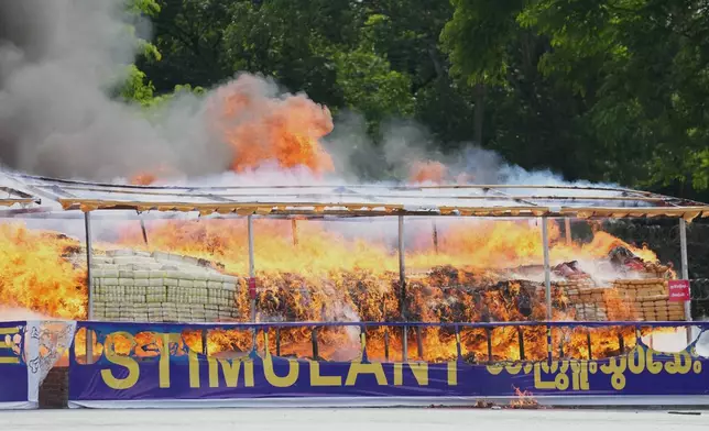 Smoke and flame rise from burning illegal narcotics during a destruction ceremony marking the U.N.’s International Day Against Drug Abuse and Illicit Trafficking, on the outskirts of Yangon, Myanmar, Friday, June 26, 2026. (AP Photo/Thein Zaw)