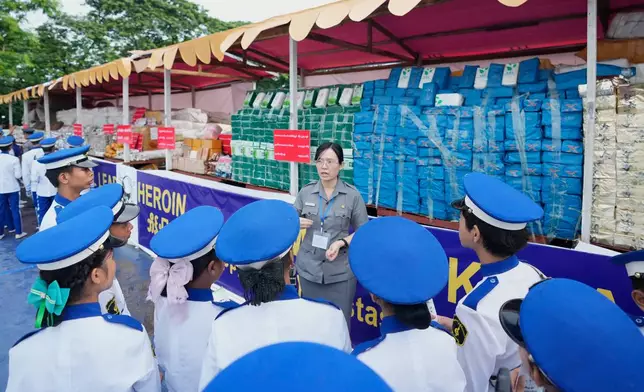 A police officer explains about illegal narcotics to attendees during a destruction ceremony marking the U.N.’s International Day Against Drug Abuse and Illicit Trafficking, on the outskirts of Yangon, Myanmar, Friday, June 26, 2026. (AP Photo/Thein Zaw)