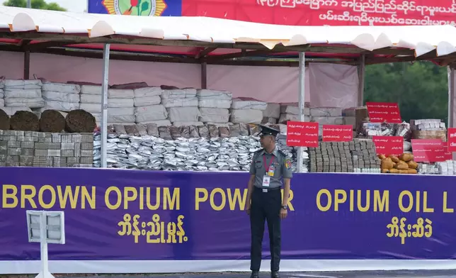 A police officer stands in front of seized illegal narcotics during a destruction ceremony marking the U.N.’s International Day Against Drug Abuse and Illicit Trafficking, on the outskirts of Yangon, Myanmar, Friday, June 26, 2026. (AP Photo/Thein Zaw)
