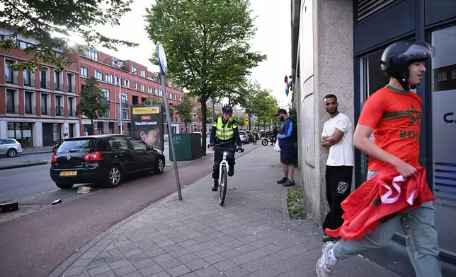 Police chases a Moroccan fan after a World Cup soccer match between the Netherlands and Morocco in The Hague, Netherlands, Tuesday, June30, 2026. (AP Photo/Mouneb Taim)