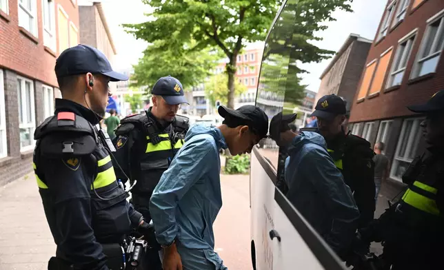 Police arrest a Moroccan fan after a World Cup soccer match between the Netherlands and Morocco in The Hague, Netherlands, Tuesday, June30, 2026. (AP Photo/Mouneb Taim)