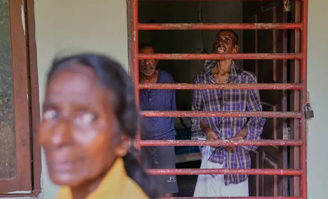 The mother of a resident stands outside a dormitory at a nursing home in Anguruwatota, Sri Lanka, Friday, June 5, 2026. (AP Photo/Eranga Jayawardena)