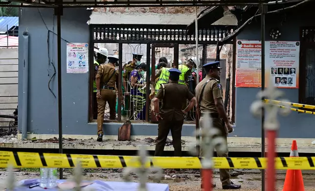 Sri Lankan police and judiciary officials inspect a charred elderly care home following an overnight fire in Anguruwatota, Sri Lanka, Thursday, June 4, 2026. (AP Photo)