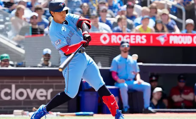 Toronto Blue Jays' Kazuma Okamoto (7) hits an RBI single during the econd inning of a baseball game against the Baltimore Orioles, Saturday, June 6, 2026, in Toronto. (Frank Gunn/The Canadian Press via AP)