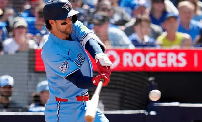 Toronto Blue Jays' Ernie Clement (22) hits a three-run home run during the third inning of a baseball game against the Baltimore Orioles, Saturday, June 6, 2026, in Toronto. (Frank Gunn/The Canadian Press via AP)