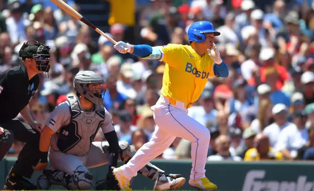 Boston Red Sox's Masataka Yoshida, right, follows through on his swing as he hits a single in front of New York Yankees catcher Austin Wells, center, in the third inning of a baseball game, Saturday, June 27, 2026, in Boston. (AP Photo/Steven Senne)