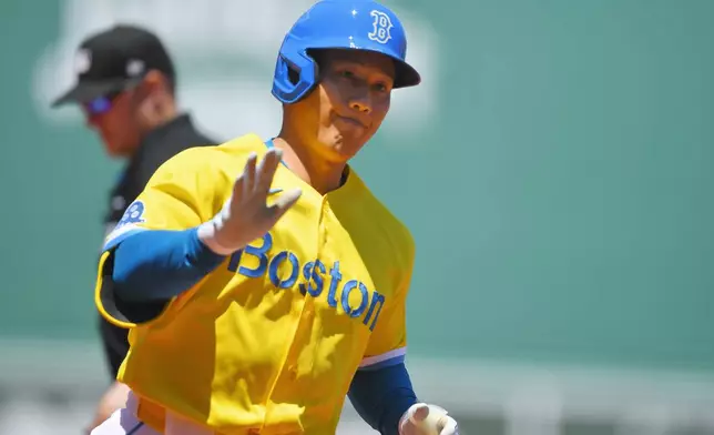 Boston Red Sox's Masataka Yoshida celebrates as he crosses home plate to score on his home run in the first inning of a baseball game against the New York Yankees, Saturday, June 27, 2026, in Boston. (AP Photo/Steven Senne)