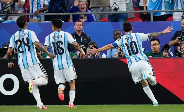 Argentina's Lionel Messi, right, celebrates after scoring his team's first goal during the World Cup Group J soccer match between Argentina and Algeria in Kansas City, Mo., Tuesday, June 16, 2026. (AP Photo/Charlie Riedel)
