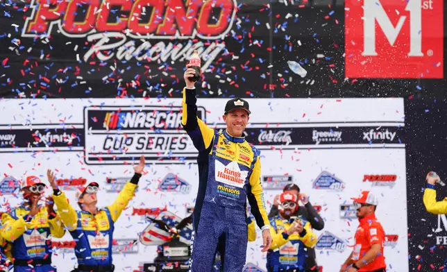 Denny Hamlin celebrates in Victory Lane after winning a NASCAR Cup Series auto race at Pocono Raceway, Sunday, June 14, 2026, in Long Pond, Pa. (AP Photo/Derik Hamilton)